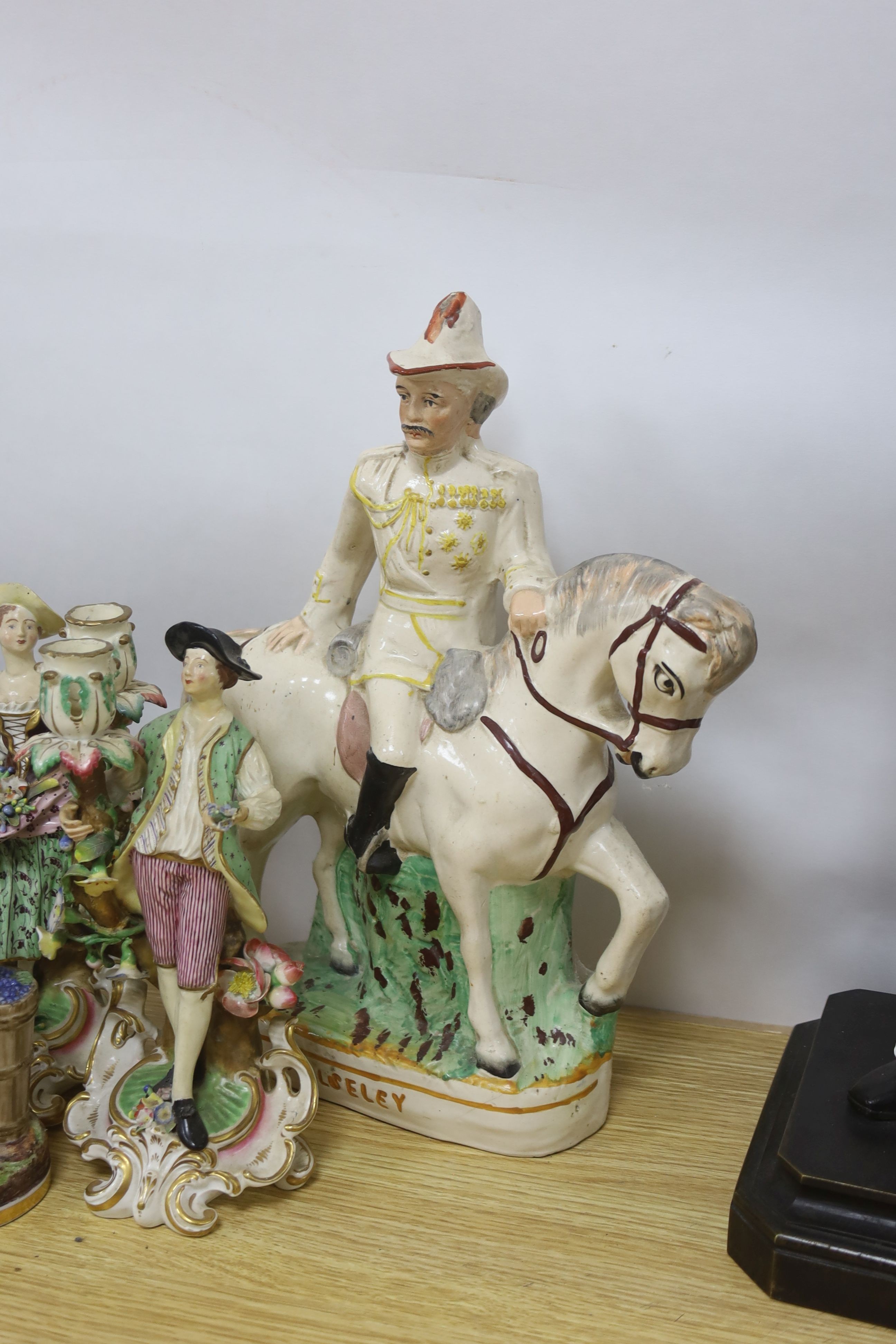 A pair of Derby candlestick figures, c.1775, 23.5 cm, a 19th century faience jardiniere or wine cooler, a Staffordshire group ‘Wolseley’ and other ceramics